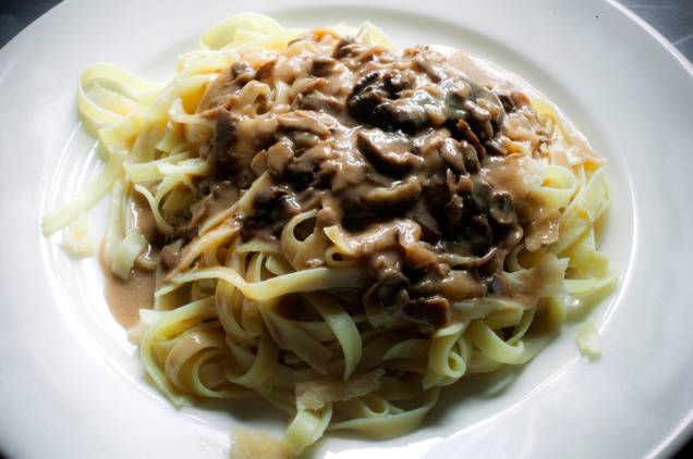 La premigina: fettucine feito em uma roda de queijo parmesão com azeite trufado, flambado na grappa e servido com molho forestier