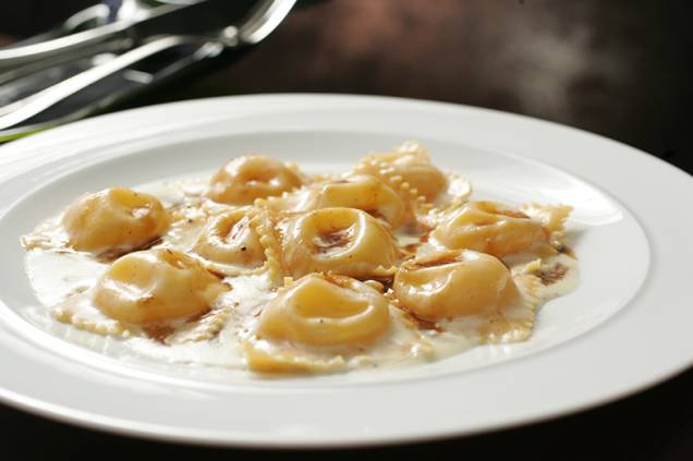 Tortelli de queijo brie ao creme de parmesão aromatizado por manteiga de trufa branca e molho rôti