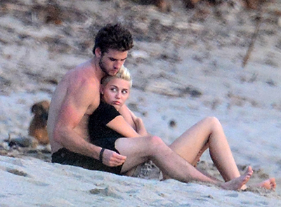 Exclusive – Miley Cyrus & Fiance Liam Hemsworth Cuddle Up on the Beach Watching the Sunset