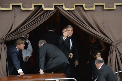 Clooney dá um alô aos paparazzi no local da cerimônia particular 