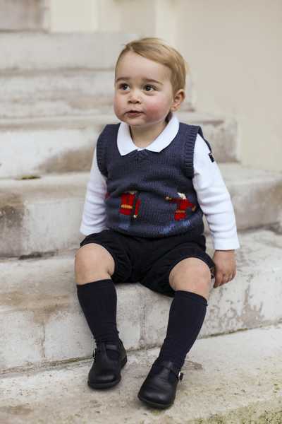 Britain’s Prince George poses in a courtyard at Kensington Palace in London in this one out of three official Christmas photographs of him