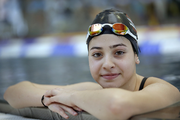 FILE - This is a Monday, Nov. 9, 2015 file photo of Yusra Mardini from Syria poses during a training session in Berlin, Germany. They’ve fled war and violence in the Middle East and Africa. They’ve crossed treacherous seas in small dinghies and lived in dusty refugee camps.They include a teenage swimmer Yusra Mardini from Syria, long-distance runners from South Sudan and judo and taekwondo competitors from Congo, Iran and Iraq. They are striving to achieve a common goal: To compete in the Olympics in Rio de Janeiro. Not for their home countries, but as part of the first ever team of refugee athletes.(AP Photo/Michael Sohn, File)