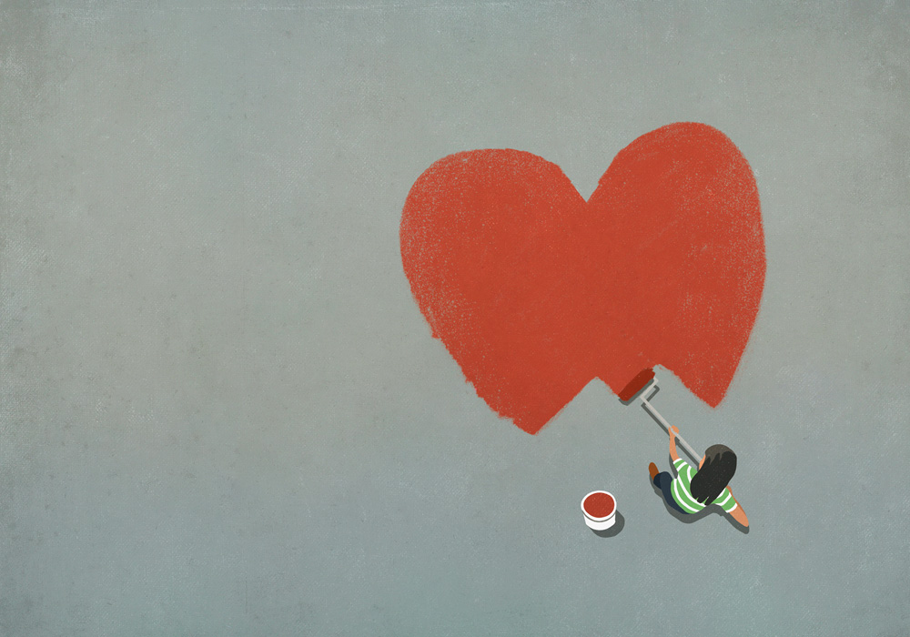 Mulher pintando um coração vermelho com rolo de pintura
