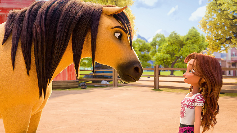 A imagem mostra uma cena de Spirit. Na animação, o cavalo encara uma menina, ele com cara séria, e ela um pouco assustada mas sorridente