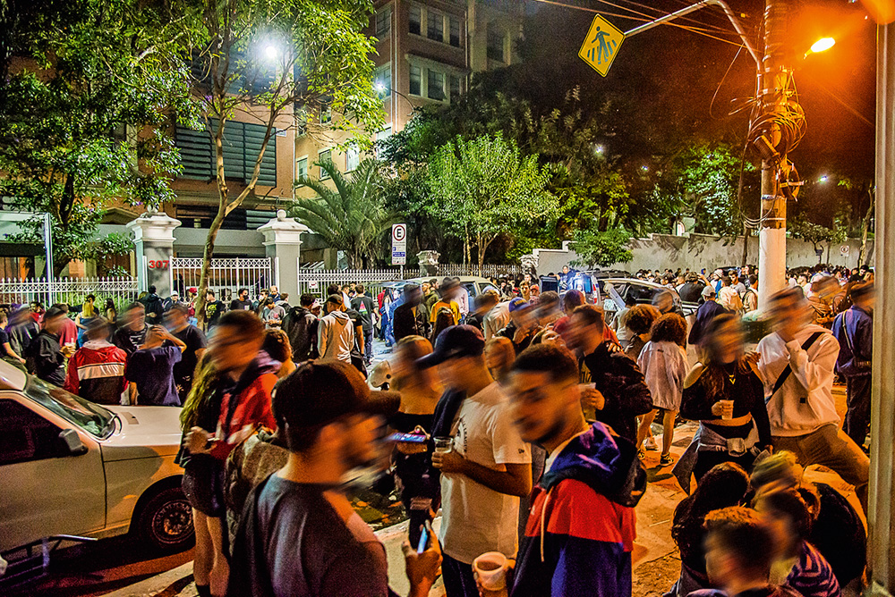muitas pessoas bebendo e conversando em aglomeração de rua durante a pandemia na rua maria antônia