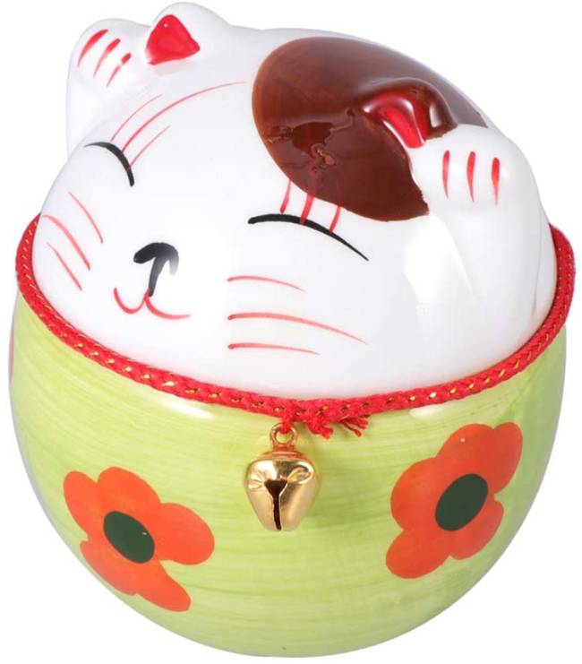 cofrinho de moedas Japão Um cofrinho de moedas de forma arredondada estampado com um gatinho da sorte japonês