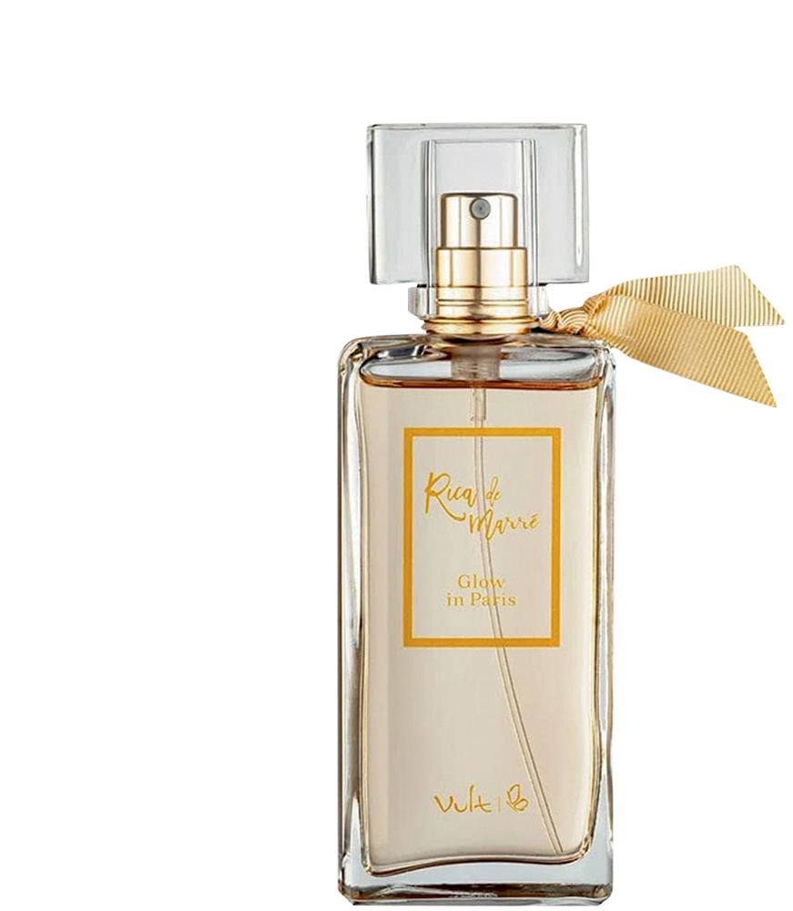 glow in paris.jpg Frasco de perfume de vidro transparente com líquido bege, um laço bege e detalhes no frasco em bege