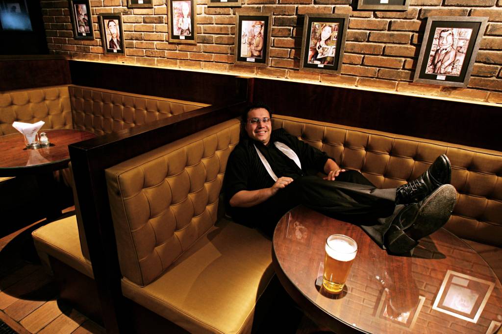 Marcelo Serrano, barman do MyNY Bar, posa no ambiente do estabelecimento