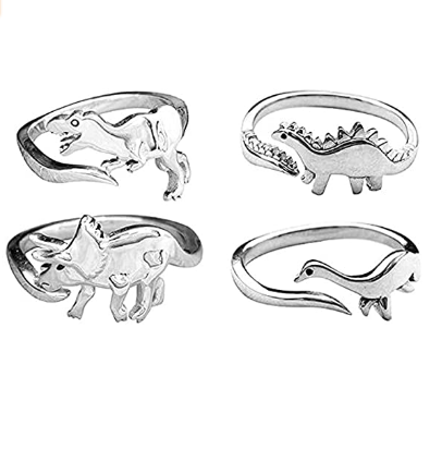 Quatro anéis com detalhes de um dinossauro diferente em cada um deles