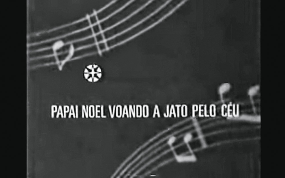 Screen Shot 2021-12-15 at 13.53.10.png Comercial antigo mostra uma letra de uma canção natalina. A imagem, pela idade, está em preto e branco.