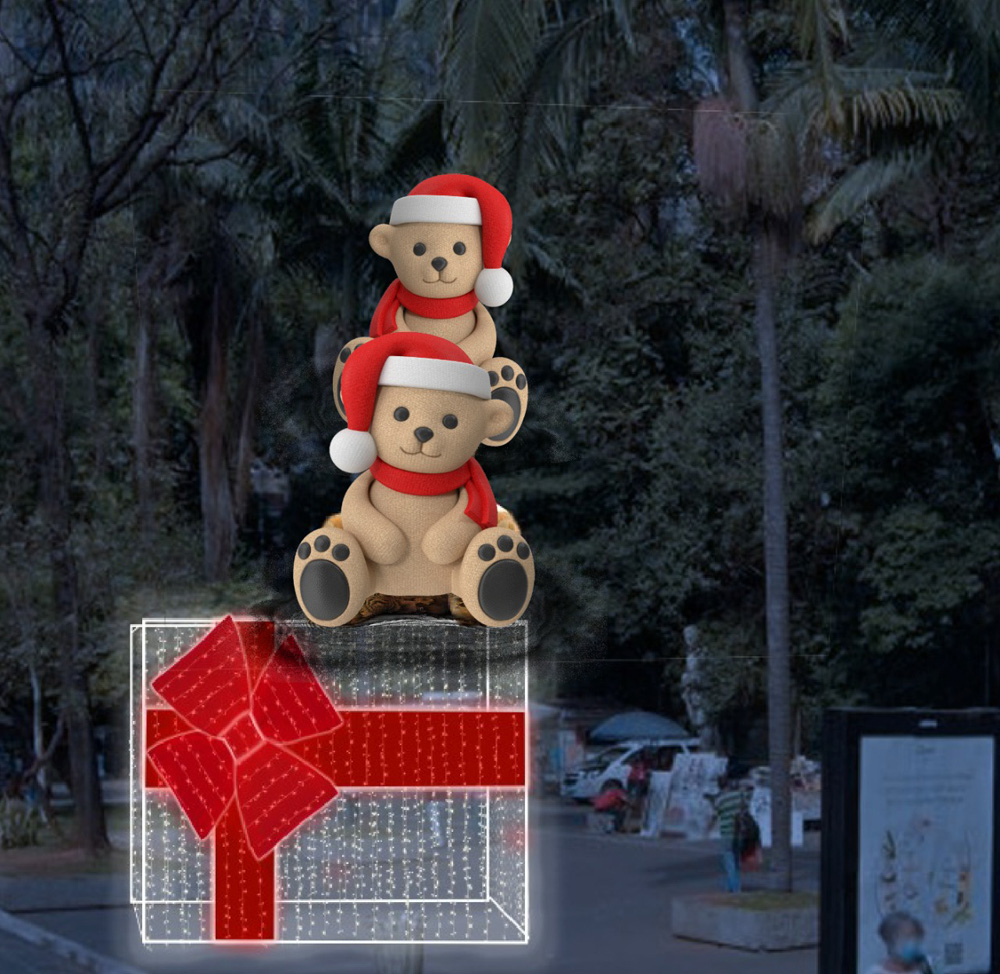 Uma projeção mostra uma caixa de presente de Natal e dois ursinhos natalinos acima dela