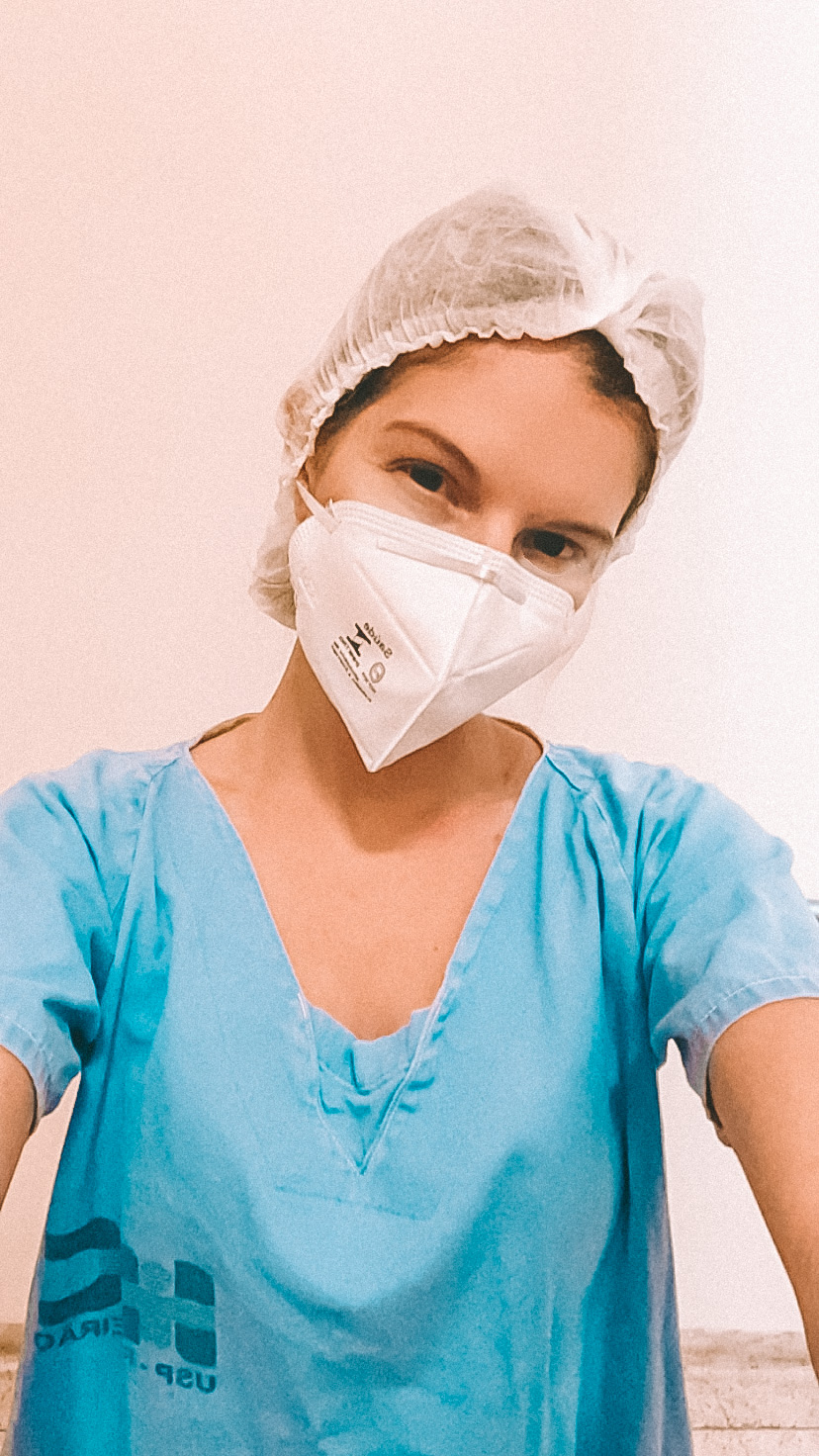 A estudante Verena Paccola com máscara e avental de técnica de enfermagem