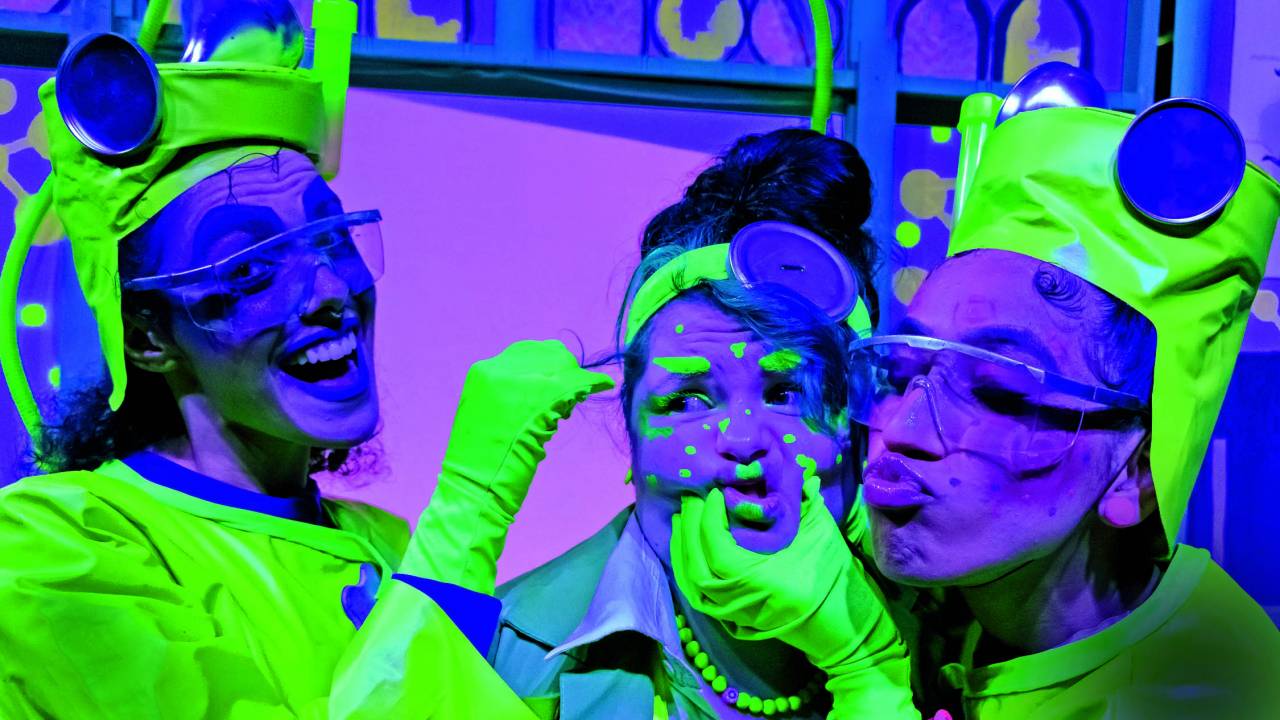 Imagem mostra três mulheres com roupas neon fazendo caretas