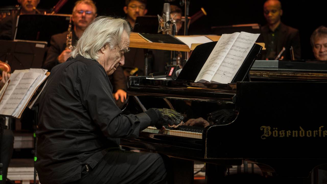 Maestro João Carlos Martins usando as luvas biônicas que lhe permitiram voltar a tocar piano