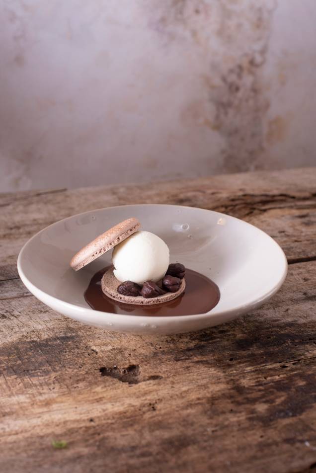 Tiramisù: releitura em forma de macaron de café sobre calda de chocolate amargo com recheio de ganache de conhaque mais sorvete de mascarpone