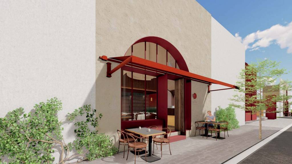 Projeção 3D que mostra a fachada de um restaurante com portas vermelhas e mesas na calçada.