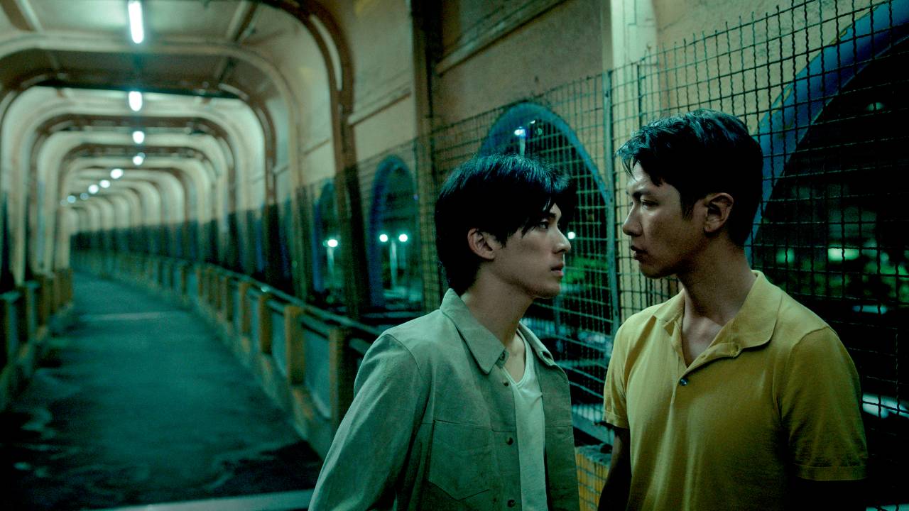 Dois jovens chineses se encaram em corredor de avenida.