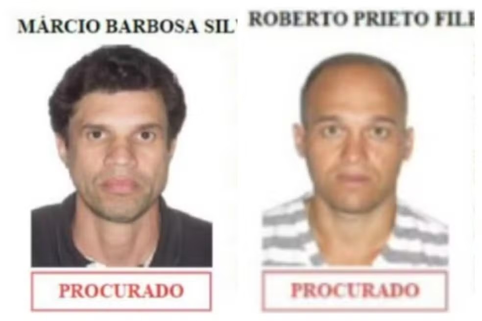 Duas fotos de homens procurados. À esquerda, Márcio Barbosa Silva, com cabelo escuro e barba rala, vestindo camisa preta. À direita, Roberto Prieto Filho, careca, com barba por fazer, vestindo camiseta listrada cinza e branca. Ambos com expressão séria e fundo branco, com a palavra PROCURADO em destaque abaixo de cada imagem